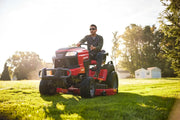 Photo of Craftsman riding lawn mower CM14AHA6ZMA93 on grass, outdoor daylight, product front view.
