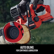 Photo of Craftsman cordless chainsaw CMCCS610B auto oiling feature cutting wood outdoors.