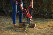 Photo of a person using a Craftsman CMCCSL621D1 cordless pruner on a small tree branch outdoors.