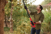 Photo of Craftsman CMCCSP20M1 pole saw in use outdoors pruning tree branches.