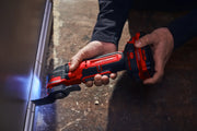 Photo of Craftsman cordless oscillating tool CMCE565B in use, cutting near a wall with an LED light.
