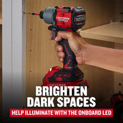Photo of a CRAFTSMAN cordless impact driver CMCF830D2 in use, driving a screw into wood, onboard LED light visible.