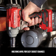 Photo of Craftsman cordless impact wrench CMCF920B in use, red and gray design, held near vehicle engine.