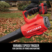 Photo of Craftsman cordless leaf blower CMCK397M1 in use, red and black design, outdoors with fallen leaves.