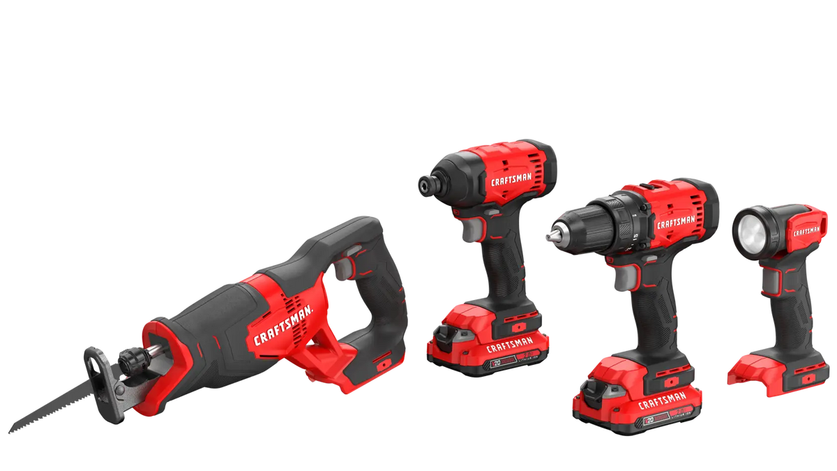 A set of four cordless Craftsman power tools, including a reciprocating saw, an impact driver, a drill, and a flashlight, all with red and black handles and rechargeable batteries attached.