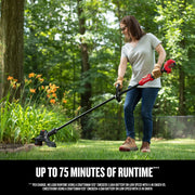 Photo of CRAFTSMAN cordless string trimmer CMCK497P1 in use on grass near flower beds outdoors.