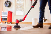 Photo of Craftsman power scrubber CMCPS520B cleaning wet garage floor with adjustable handle.