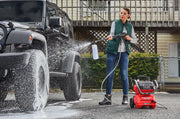 Person washing black SUV with Craftsman pressure washer CMCPW1500N2, soap spraying, outdoor setting.