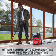 Photo of a person cleaning a porch floor with a Craftsman cordless pressure washer CMCPW1500N2, red color, outdoor use.