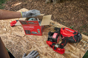 A close-up of a woodworking setup featuring a CRAFTSMAN box of coil nails, a battery pack, and a red and black CRAFTSMAN