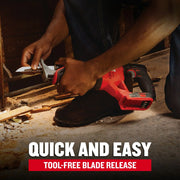 A person is installing or removing the blade from a red and black CRAFTSMAN reciprocating saw. The image highlights the tool-free blade release feature and includes text that reads 'Quick and Easy, Tool-Free Blade Release.' The saw is being used in a construction or renovation setting with wood debris on the floor.