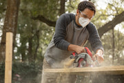 Craftsman CMCS551B cordless circular saw cutting wood, close-up, red and silver tool in use.
