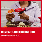 Photo of a person using a red Craftsman hot glue gun CMGL100B to attach a flower to a decorative wreath.