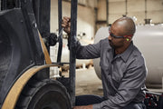 Photo of worker using CRAFTSMAN wrench SKU CMMT87350V to repair machinery in an industrial setting.
