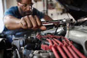 Photo of CRAFTSMAN ratchet tool, SKU CMMT99154L, being used on a car engine in automotive repair.