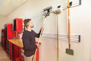 Photo of Craftsman wall track storage system, SKU CMST22000, mounted in a garage holding garden tools.