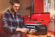Photo of Craftsman tool chest SKU CMST98245RB open on a workbench with tools and a person using equipment.