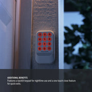 Photo of Craftsman wall-mounted wireless keypad, SKU CMX348, with illuminated orange keys for nighttime use.