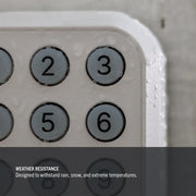Close-up of Craftsman CMX348 outdoor keypad with water droplets, highlighting weather resistance feature.