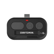 Photo of Craftsman CMX363 black three-button garage door remote with myQ logo, top angle on white background.