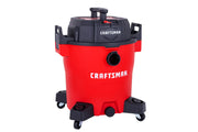 A red and black Craftsman wet/dry vacuum cleaner with wheels, designed for heavy-duty cleaning tasks.