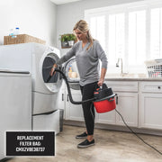 Photo of a person using a Craftsman wet/dry vacuum, SKU CMXEVBE17250, cleaning a laundry room near a dryer.