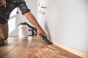 Photo of Craftsman wet/dry vacuum SKU CMXEVBE17678 cleaning dust along wood floor edge.