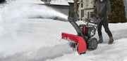 Photo of Craftsman snow blower CMXGBAM1054546 clearing snow outdoors, red and black design, person operating.