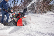 Photo of Craftsman snow blower CMXGBAM1054546 clearing snow outdoors, red and black machine in action.
