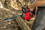 Photo of a CRAFTSMAN chainsaw CMXGSAMY42N6 being used to cut a log outdoors, red body, 16-inch bar visible.