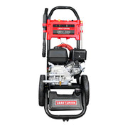 Front view of a Craftsman premium gas pressure washer with red accents, black wheels, and a hose attached. The machine displays specifications of 3100 PSI and 2.4 GPM on a label.