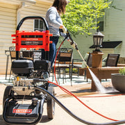 Photo of a CRAFTSMAN gas pressure washer CMXGWFN061255 being used to clean a patio with high-pressure water.