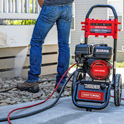 Photo of Craftsman pressure washer CMXGWFN061325 in use, cleaning outdoor siding, person holding spray wand.