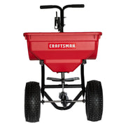 Front angle photo of Craftsman red spreader CMXGZBF450532 with large wheels and black handle on white background.