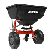Photo of Craftsman tow-behind spreader CMXGZBF4505561 with black hopper and red frame, front angle.