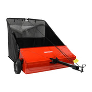 Front angle photo of Craftsman lawn sweeper CMXGZBF45521 with red body, black mesh hopper, and tow bar.