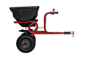 Photo of Craftsman tow-behind spreader, SKU CMXGZBF7124322, black hopper, red frame, side view.