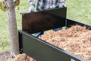 Photo of Craftsman CMXGZBF7124355 utility cart with black steel side panel, filled with mulch, outdoor setting.