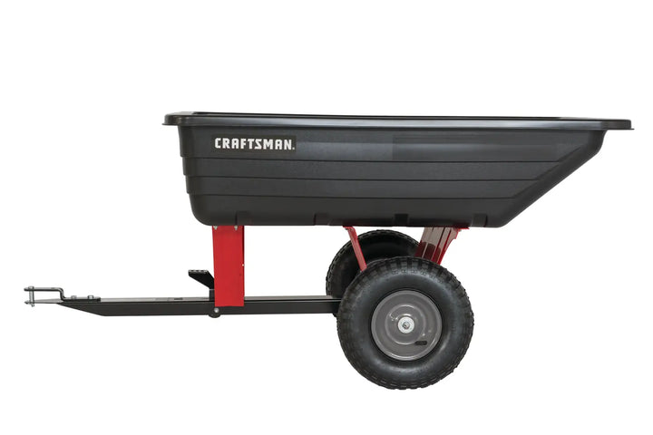 Photo of CRAFTSMAN garden dump cart, SKU CMXGZBF7124489, black poly tray, red frame, side angle on white background.
