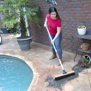 Photo of CRAFTSMAN CMXMLBA7218A outdoor broom used to sweep debris near a pool on a patio.