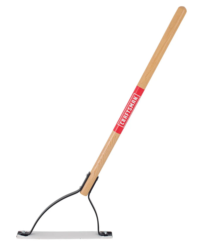 A long-handled garden tool with a wooden handle and a flat metal blade, commonly known as a scraper or hoe, designed for outdoor use. The handle features a red label with white text.