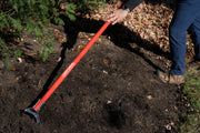 Photo of Craftsman garden leveling rake CMXMLTP35334 with red handle in use on soil outdoors.