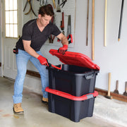 Photo of a person opening a CRAFTSMAN storage tote, SKU CMXXPBP20GT, black with red lid, in a garage.