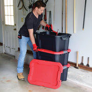 Photo of a person organizing tools in a garage using two stacked CRAFTSMAN black and red storage bins, SKU CMXXPBP20GT.