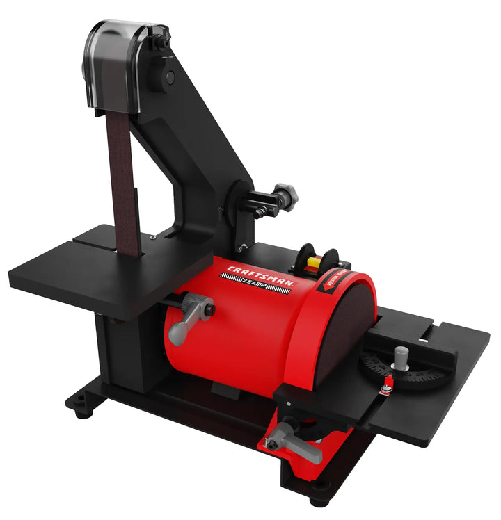 A bench-top power sander with a red and black metal body, featuring a vertical belt sanding area on the left and a round disc sanding area on the right, designed for woodworking and other material sanding tasks. The brand name 'Craftsman' is visible on the red part of the machine.