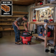 Photo of Craftsman wet/dry vacuum CMXZVBE37035 in a workshop beside a workbench with tools.