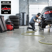 Photo of CRAFTSMAN CMXZVBE37035 wet/dry vacuum in garage near stacked tires and tools, mechanic working on car.