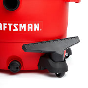 Photo of Craftsman wet/dry vacuum CMXZVBE38621 base, showing red body, wheel, drain cap, and black handle, front angle.