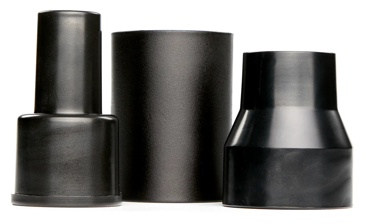 Three black plastic cylindrical photography accessories, possibly lighting modifiers or adapters, are standing upright side by side on a white background.