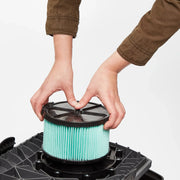 Photo of CRAFTSMAN filter installation, model CMXZVBE38740, being placed in a vacuum base, close-up angle.